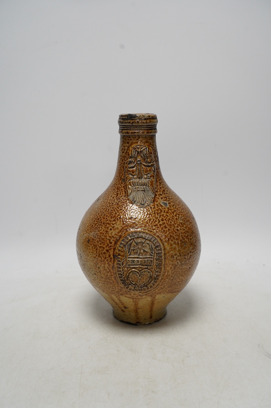 A 17th century Rhenish saltglazed Bellarmine, 23cm. Condition - commensurate with age